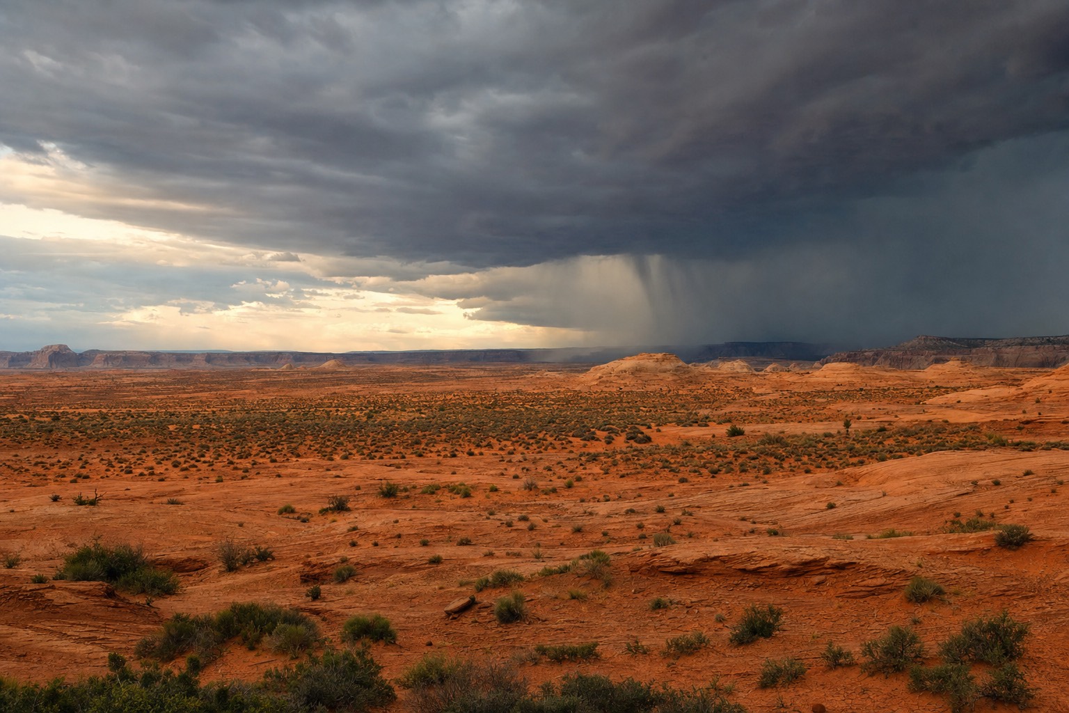 Dark monsoon storm cell building over orange sandstone desert near Page, Arizona