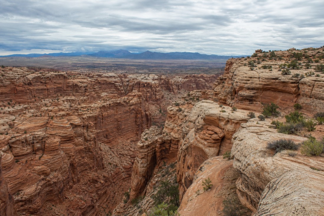 Overcast sky above slot canyon rim country with muted light and no shadows on the rock