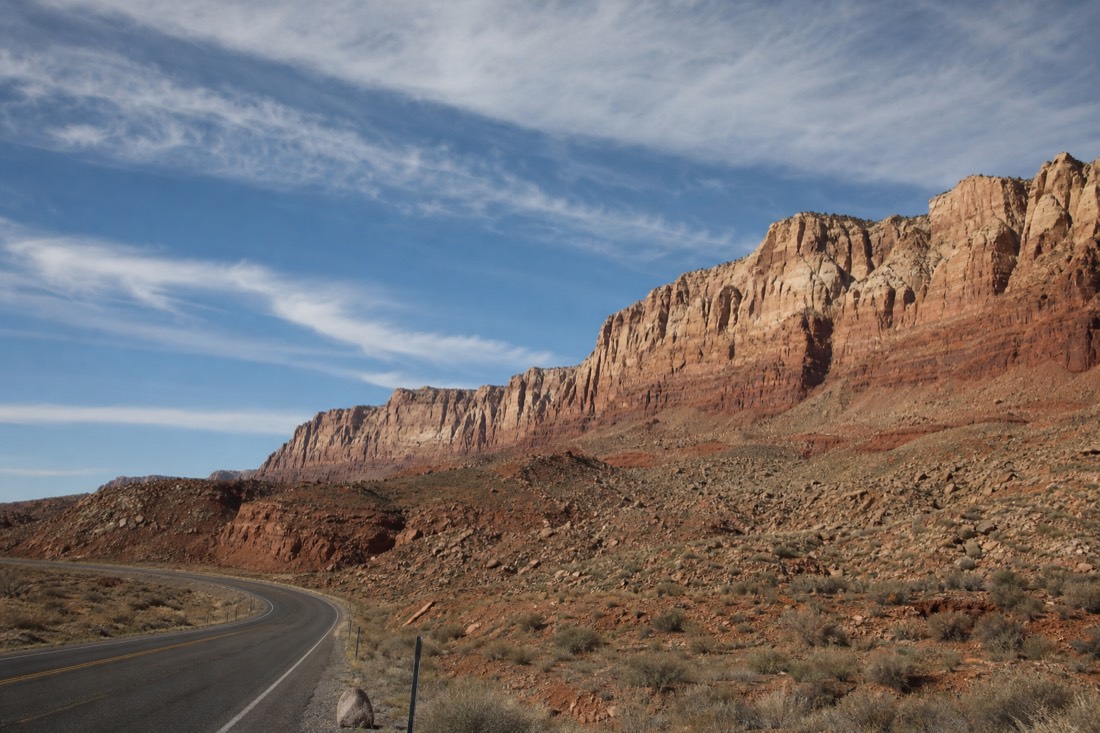 Echo Cliffs rising beside US-89 under a wide blue Arizona sky