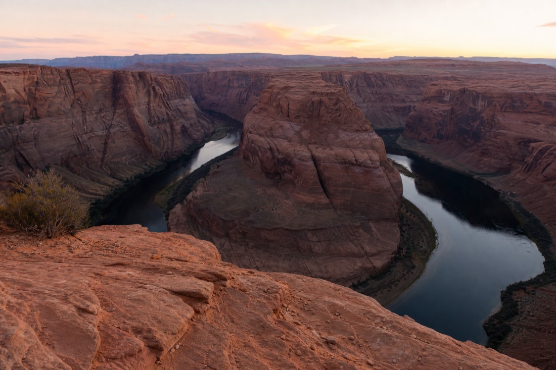 Soft dawn light over the Colorado River bend with empty rim and pastel sky near Page Arizona