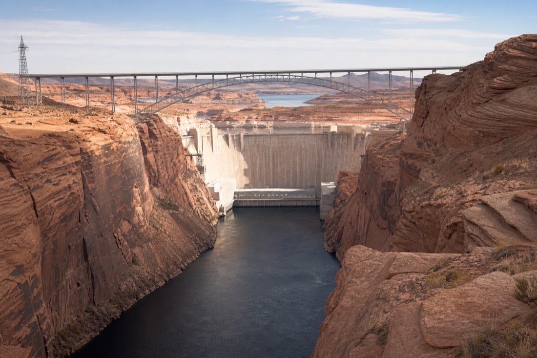 Glen Canyon Dam and bridge spanning the Colorado River gorge seen from a rim overlook