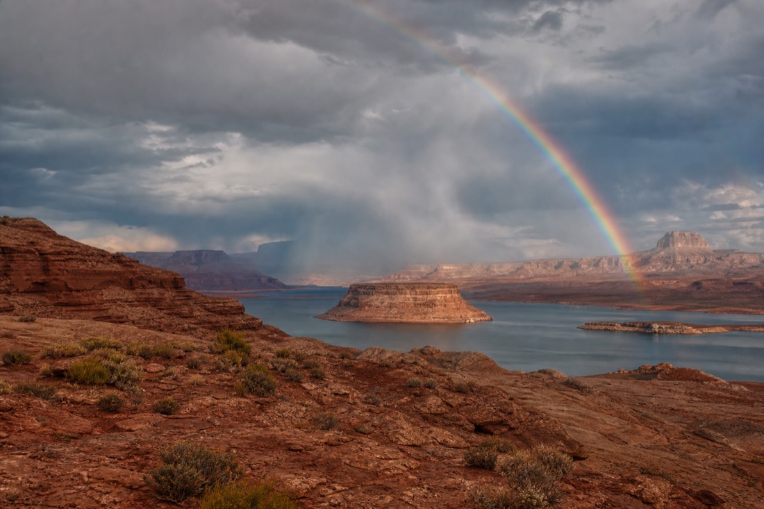 Storm light and rainbow over Lake Powell mesas in monsoon season