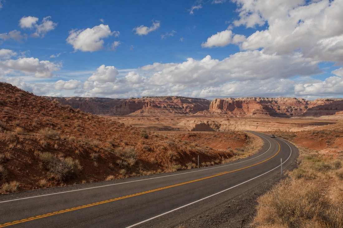 Desert highway near Page Arizona leading toward slot canyon country in afternoon light
