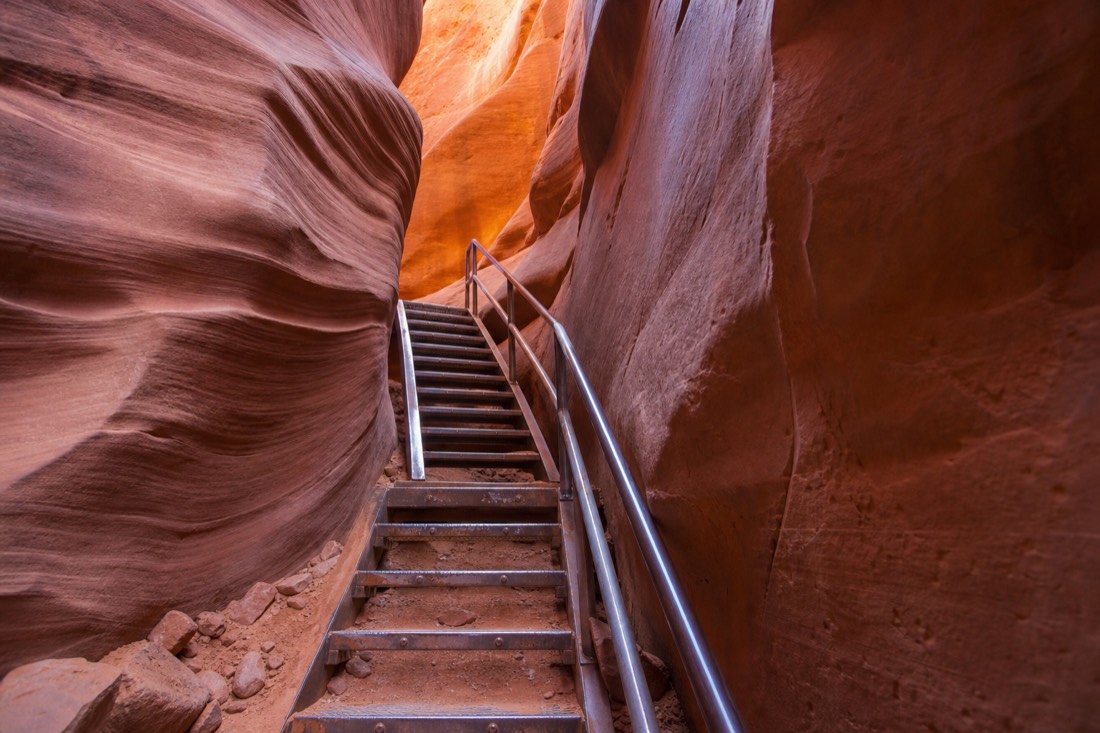 Modern bolted metal stairway providing a fixed exit route inside Lower Antelope Canyon