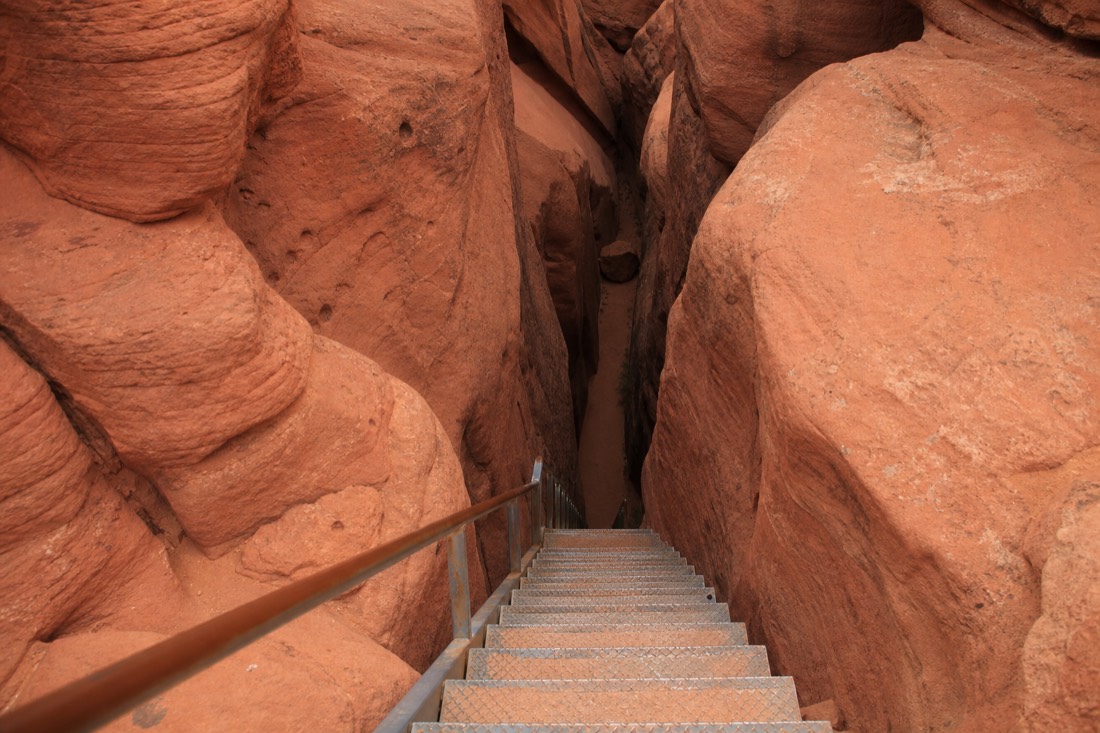 Visitors on a guided walk between the sculpted orange walls of Lower Antelope Canyon